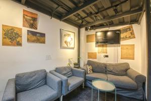 a living room with two couches and a table at Hidden Garden Youth Hostel -Oriental Pearl &Lujiazui -Garden Social Area -Bar -Café -Free Laundry Luggage Storage -24H Front Desk -English Service in Shanghai