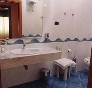 a bathroom with a sink and a toilet at Hotel Daniela in Talsano