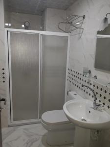 a bathroom with a shower and a toilet and a sink at Toprak Hotel in Van