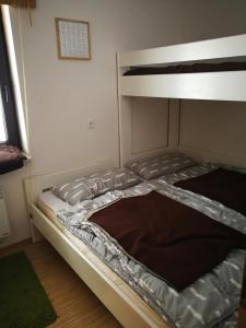 a bed in a room with a bunk bed at Planika B&M in Bohinj