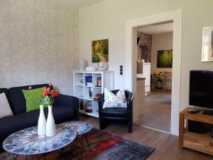 a living room with a couch and a table with vases on it at Mia Casa in Morsbach