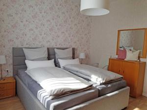 a bed with two pillows on it in a room at Mia Casa in Morsbach