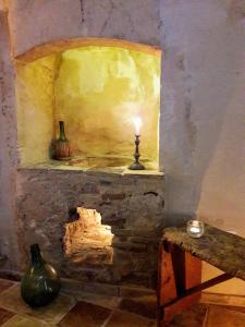 a room with a fireplace with a candle on it at Cave Rooms Sassi in Matera