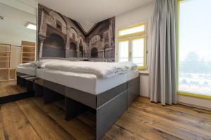 a bedroom with a large bed and a large window at Boutique Hotel BS16 before Bern City Parking gratis in Bern