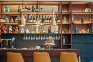 a bar with chairs and bottles on the shelves at Hotel Mrak Superior in Ljubljana