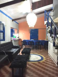 a living room with a couch and a table and chairs at Casa de praia para sonhar in Luis Correia