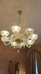 a chandelier hanging from a ceiling in a room at Casa Pisani Canal in Venice