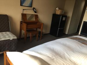 
Tempat tidur dalam kamar di Eco and Tec Kyoto
