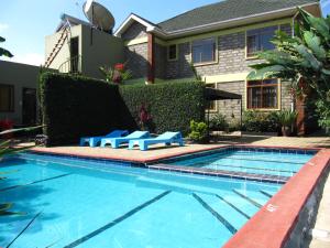 a swimming pool in front of a house at Korona Villa Lodge in Arusha