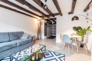 a living room with a blue couch and a table at Central & Cosy Apartment Strasbourg City Center in Strasbourg