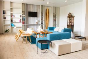 a living room with a blue couch and a table at Star inn Peniche in Peniche