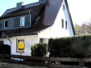 a white house with a black roof at Ferienhaus SUN Schein in Templin in Templin