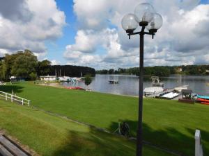 a street light next to a river with boats on it at Ferienhaus SUN Schein in Templin in Templin