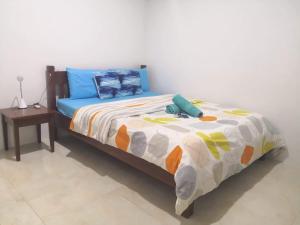 a bedroom with a bed with a pillow and a stuffed animal on it at MoonViews Apartment in Panglao