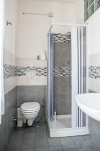 a bathroom with a shower and a toilet and a sink at Bed and Breakfast Sofia in Pescara