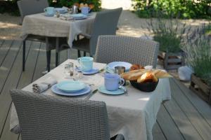 a table with a plate of food on top at Les Terrasses du Luberon in Bonnieux