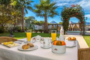 a white table with food and drinks on it at Hotel Tossal d'Altea in Altea