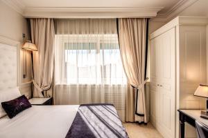 a hotel room with a bed and a window at Hotel Domus Mea in Rome