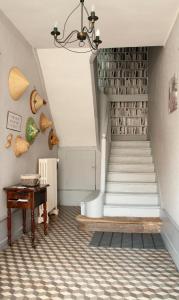 a staircase in a house with a piano at LA MONGEARDIERE in Ay