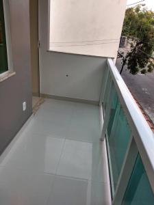 a balcony with a glass floor and a window at Seasun Suítes in Arraial do Cabo