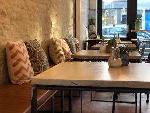 a row of tables in a restaurant with pillows at Mañana Mañana in Antwerp