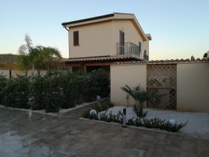 a house with a balcony on top of it at B&b A Due Passi Dal Sole in Porto Empedocle