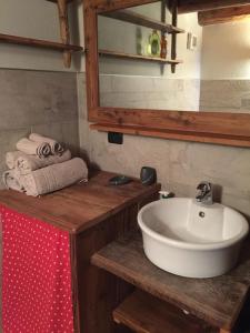 a bathroom with a sink and a mirror and towels at La Tzambretta in Aosta