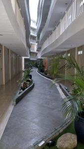 an empty hallway with plants in a building at Lelani's Comfy Condo in Mactan