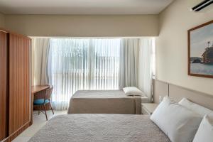 Giường trong phòng chung tại Residencial Onda Azul +22 ảnh