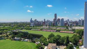 an aerial view of a park in front of a city at Privilege Studios in Terrazas Polo in Buenos Aires