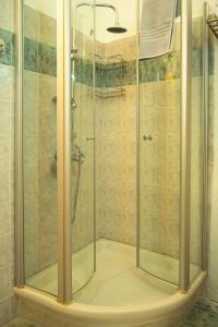 a shower with a glass door in a bathroom at Venetula's Mansion in Kastoria