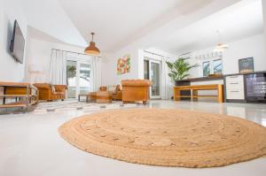 a living room with a large rug on the floor at SunsetLoft Vir in Vir