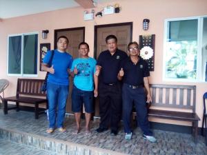 a group of people standing in front of a house at Chom Chan Guesthouse & Hostel in Chiang Mai