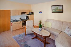 a living room with a couch and a table at Ferienwohnung Rust in Oranienbaum-Wörlitz