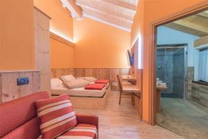 a living room filled with furniture and a large window at Agriturismo La Poina in Livigno