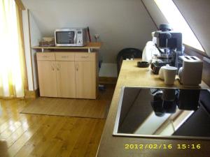 A kitchen or kitchenette at Komfort Apartman