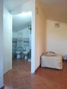 a bedroom with a bed and a bathroom with a toilet at Casa Arcobaleno in Siena