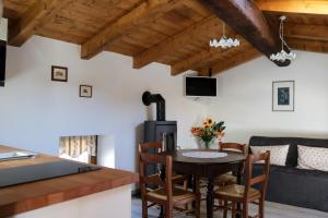 a kitchen and living room with a table and a couch at Casa del Castagno in Pulfero