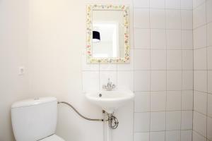 a bathroom with a toilet and a sink and a mirror at Welcome Edinborg in Eyvindarhólar