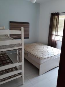 Cama o camas de una habitación en Apartamentos Bombinhas