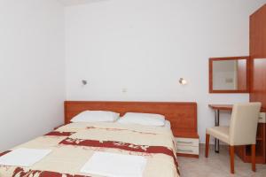 Postel nebo postele na pokoji v ubytování Apartments & Rooms Konoba Tomić