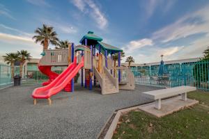 a playground with a slide and a bench at St. George Inn and Suites in St. George