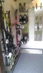 a group of skis and snowboards hanging on a wall at Biancas Ferienwohnung im Haus Roswitha in Tumpen