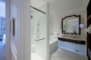 a white bathroom with a sink and a shower at Copacabana Palace, A Belmond Hotel, Rio de Janeiro in Rio de Janeiro