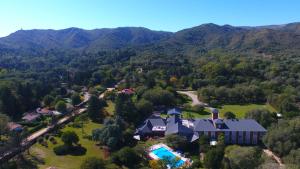 an aerial view of a house in the mountains at Howard Johnson Hotel & Spa Villa General Belgrano in Villa General Belgrano