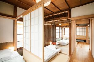 two beds in a room with windows at Minato-ku - House / Vacation STAY 12127 in Tokyo