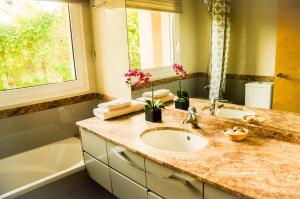 a bathroom with a sink and a mirror and a tub at B&B Tina de Pacs, close to local wineries in Pacs del Penedes