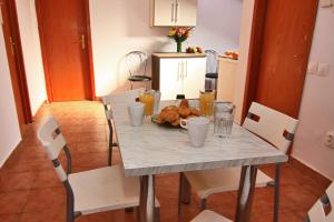 a table with a plate of food on it at City Center Apartments & Suites by RDC in Bucharest