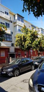 a black car parked in front of a building at Sevilla Nervión piso con Patio in Seville