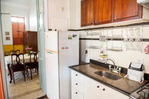 a kitchen with a sink and a refrigerator at Rio Antigo in Rio de Janeiro +14 photos